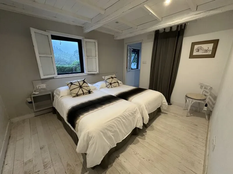 Bedroom with two single beds and a window onto the vineyards, Casa da Viña