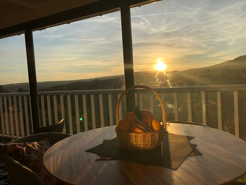 Sunset over the Miño valley through the living-room window, with a basket of homegrown oranges, Casa da Viña